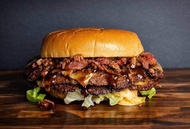 Smoky Manhattan burger with smoked gouda, bacon crumbles, smokey mayo, and bourbon sauce from a Holland Michigan food truck